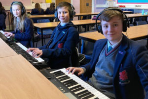 Students using keyboards in music