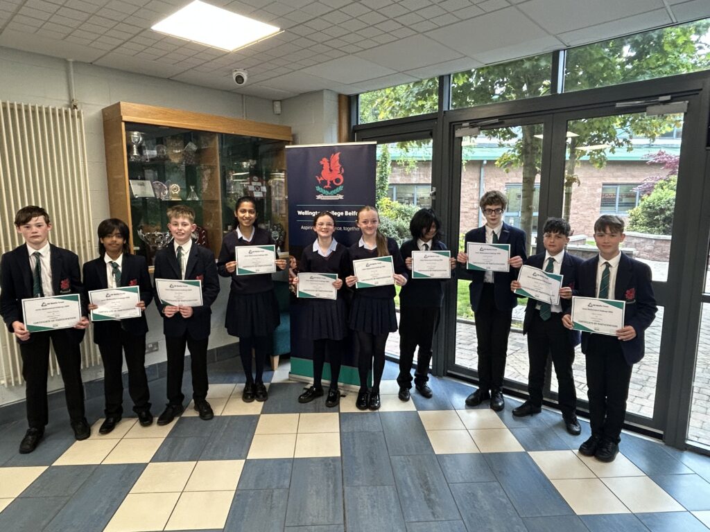 Maths challenge winners holding certificates